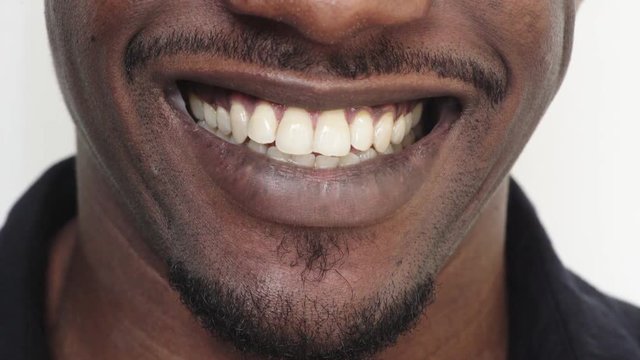 close up african american man mouth smiling cheerful happy showing healthy white teeth dental health concept
