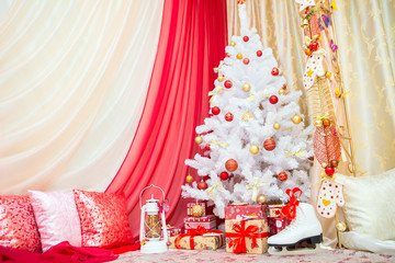 Christmas decorations. Happy New Year. Antique lantern, Christmas balls, gift boxes with ribbons. White Christmas tree with balls