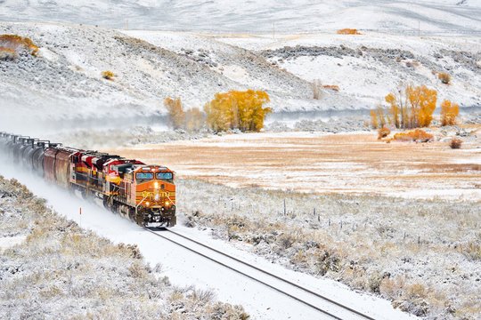 Fototapeta Train transporting tank cars. Season changing autumn to winter.