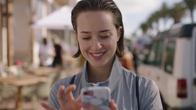portrait of attractive young woman on summer vacation using phone browsing shopping online