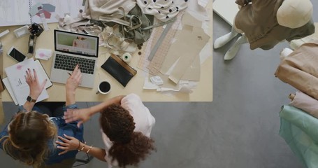 young fashion designer women working together in startup business studio designing stylish clothes successful female manager brainstorming marketing ideas using laptop