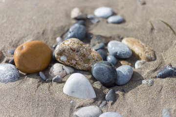 Fototapeta na wymiar еarly-colored stones on the beach