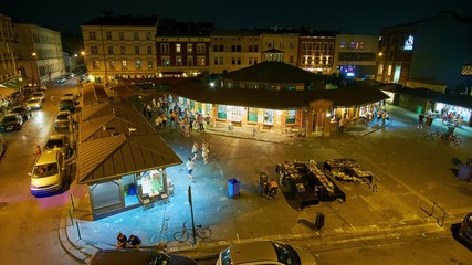 KRAKOW, POLAND - JUNE 21, 2018: The evening on New Square (Plac Nowy) of Kazimierz Jewish Quarter with popular tourist cafes and bars, on June 21 in Krakow. 