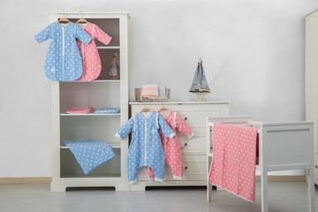 Modern baby bedroom in white with bed, bookcase, and carpet