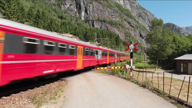 Aerial view of passenger train passing a railroad crossing.