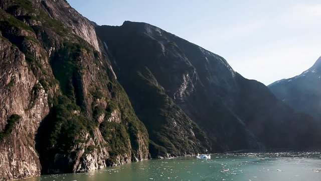 Sun shines on the stunning scenery of Tracy Arm Fjord near Juneau, Alaska. Untamed, natural wilderness and wildlife with incredible landscape. Slow motion.