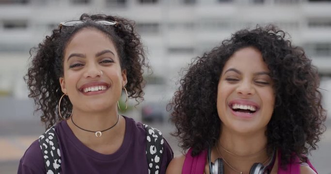 Portrait Beautiful Young Hispanic Twin Sisters Laughing Together Lively Female Siblings Enjoying Vacation Lifestyle In Urban City Looking Stylish Slow Motion