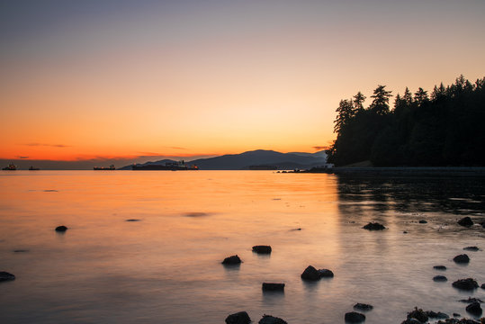 Majestic Summer Sunset over a Bay with Anchored Ships. Stanley Park, Vancouver, BC, Canada.