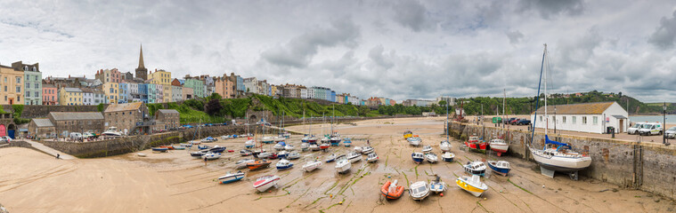 Tenby fishing port harbour at low tide, captured in a panoramic view