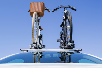 bicycle rack on top of white car
