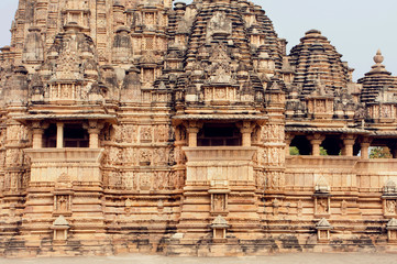 Fototapeta premium Stone walls of designed in 10th century Hindu temple in ancient Indian city Khajuraho. UNESCO World Heritage Site.