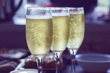 Glasses with champagne on the table with food