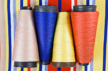 Different colors skeins on the textile background