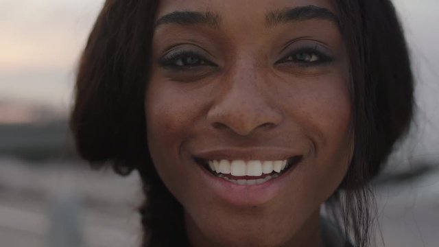 close up portrait of beautiful african american woman looking to camera smiling cheerful