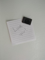 "Love you!" written on a piece of paper on the fridge 
