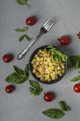 fried potatoes flat lay with tomato and basil