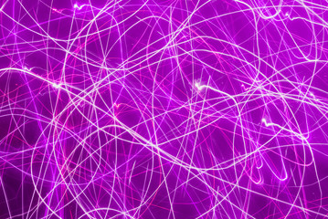 Blurred colorful lights in motion. Abstract background in purple tones