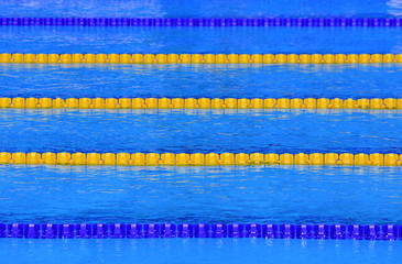 The view of an empty swimming pool indoors. Lanes of a competition swimming pool. Sport concept.