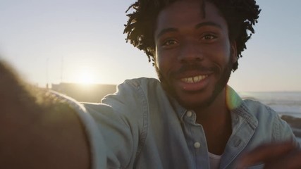 portrait of young african american man tourist waving hand talking to camera video chat smiling happy enjoying vacation 