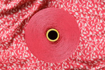 Rose colour skein on the textile background