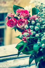 bouquet of roses and chrysanthemums on the windowsilll in vintage style