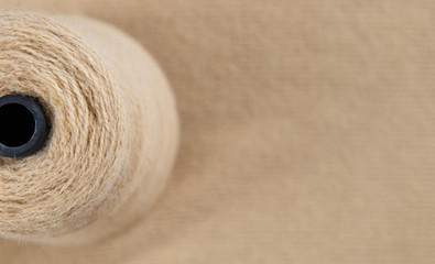 Nude colour skein on the knited textile background