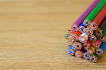 Colorful pencils isolated on wooden background, copy space, shallow focus
