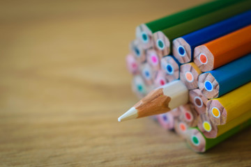 Colorful pencils isolated on wooden background, copy space, shallow focus
