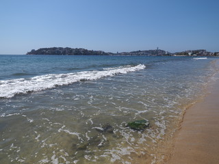 Sandy beach at wonderful landscape of bay of ACAPULCO city in Mexico with white waves of Pacific...