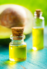 avocado oil cosmetics medicine health nature glass vial wooden background
