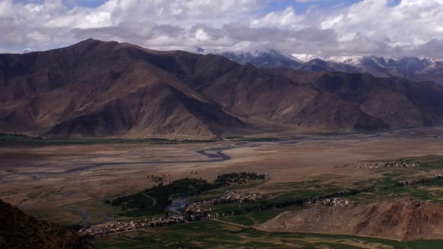 Timelapse pan right of valley landscape Tibet