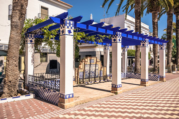 Pretty blue and white pergola in Laguna Square plaza, Ayamonte, Huelva Province, Andalucia, Spain.