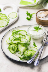 Summer healthy cucumber and fennel salad with yogurt dressing. Selective focus, space for text.