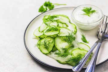Summer healthy cucumber and fennel salad with yogurt dressing. Selective focus, space for text.