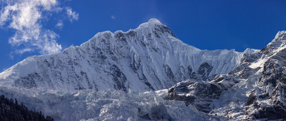 Kawagebo Peak, an unclimbed summit which is part of Meili Xue Shan - Snow Mountain range in the Yunnan province of China. Also pictured Mingyong Glacier, the lowest altitude glacier in China.