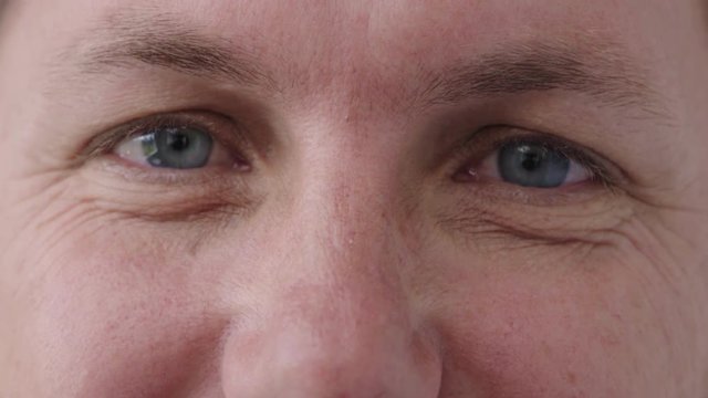 close up man blue eyes looking funny happy caucasian male healthy eyesight satisfaction