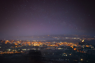 Fototapeta premium Siracusa , Italy, seen from above, with the Milky way