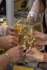 Young women drink sparkling wine at a breakfast with sparkling wine. Concept: friendship or lifestyle