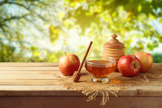 Honey and apples on wooden table. Jewish holiday Rosh Hashanah background