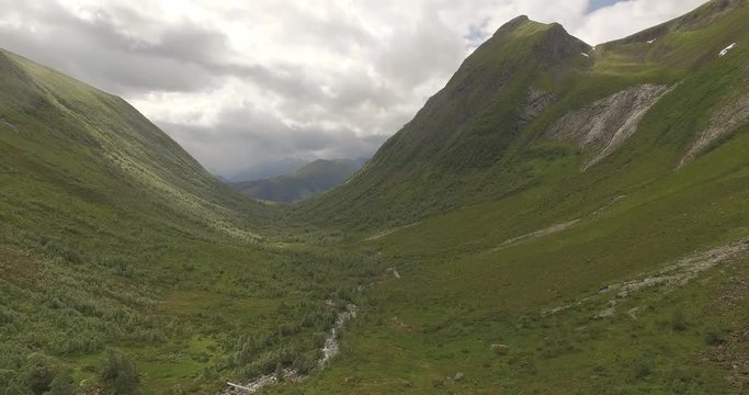 4k Drone footage paning up to beautiful valley with fjord in the background and steep moutain. Skorgedalen, orsta sunnmore Norway.