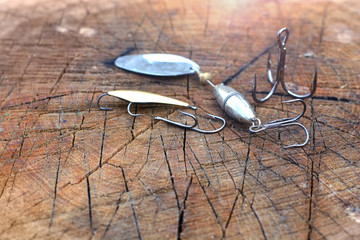 Fishing hooks on a wooden background. Fishing gear background.