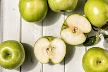 green apples on a light wooden background .fruit, health.Apple in the context of