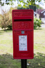 Fototapeta na wymiar Usk UK June 25th 2015 : Rural red post box in the small south Wales town of Usk, UK