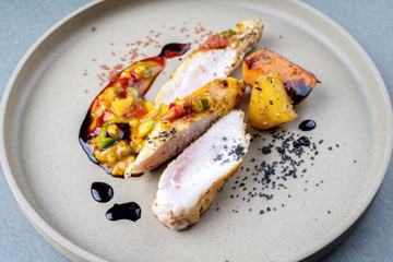 Modern barbecue crocodile tail eye fillet with roasted sweet potatoes pineapples and mango chili...