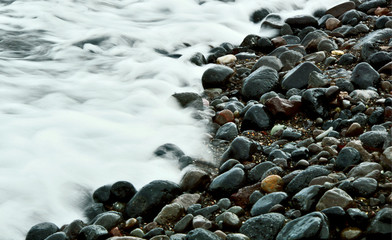 Black beach Athens Greece with Many black stone.