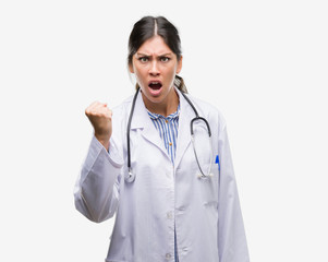 Young hispanic doctor woman annoyed and frustrated shouting with anger, crazy and yelling with raised hand, anger concept