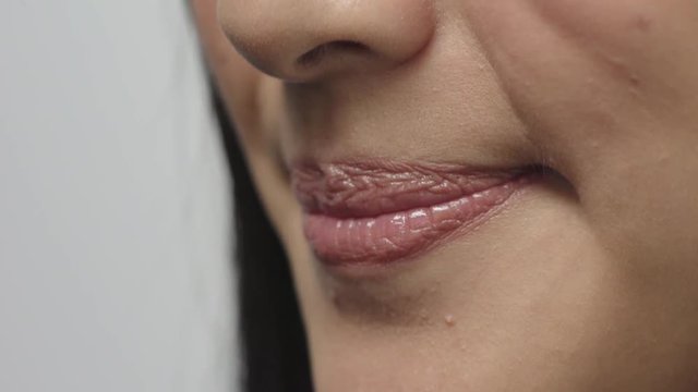 close up woman mouth smiling cheerful glossy lips healthy teeth concept on white background
