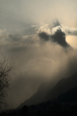Sunburst over Rüthi; moody light as the Sun disappears in cloud over the Hoher Kasten