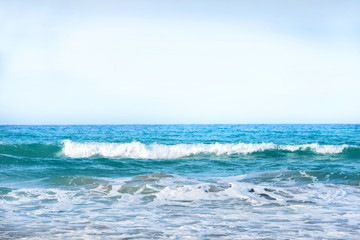 Waves on the blue sea water at a beach