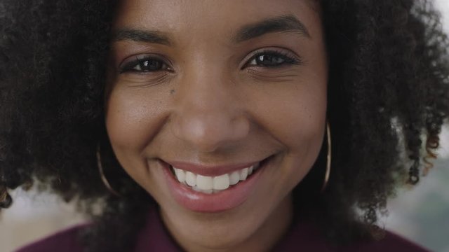 close up portrait of friendly young african american business woman smiling cheerful looking at camera enjoying successful lifestyle